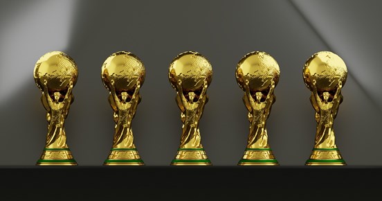 Fem guldiga troféer i rad.