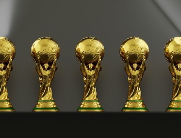 Fem guldiga troféer i rad.