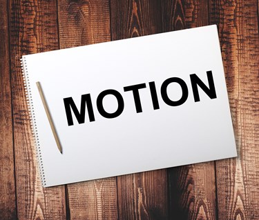 Bild på ett anteckningsblock med texten motion.