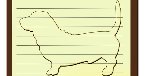 Tecknad hund av basset-typ på linjerat anteckningsblock