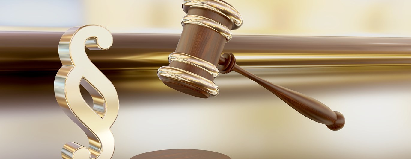 Bild som visar en paragraf i guld och en mötesklubba.