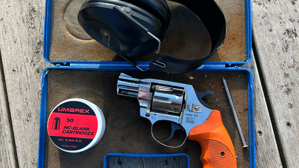 Revolver med ammunition och hörselskydd.