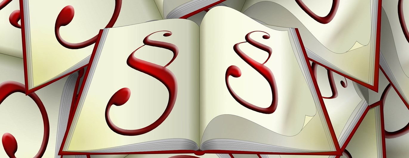 Bild som visar röda paragrafer i böcker.