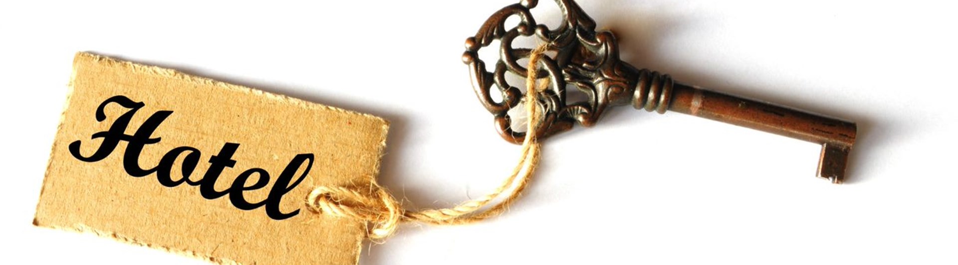 Bild som visar en gammaldags hotellnyckel.